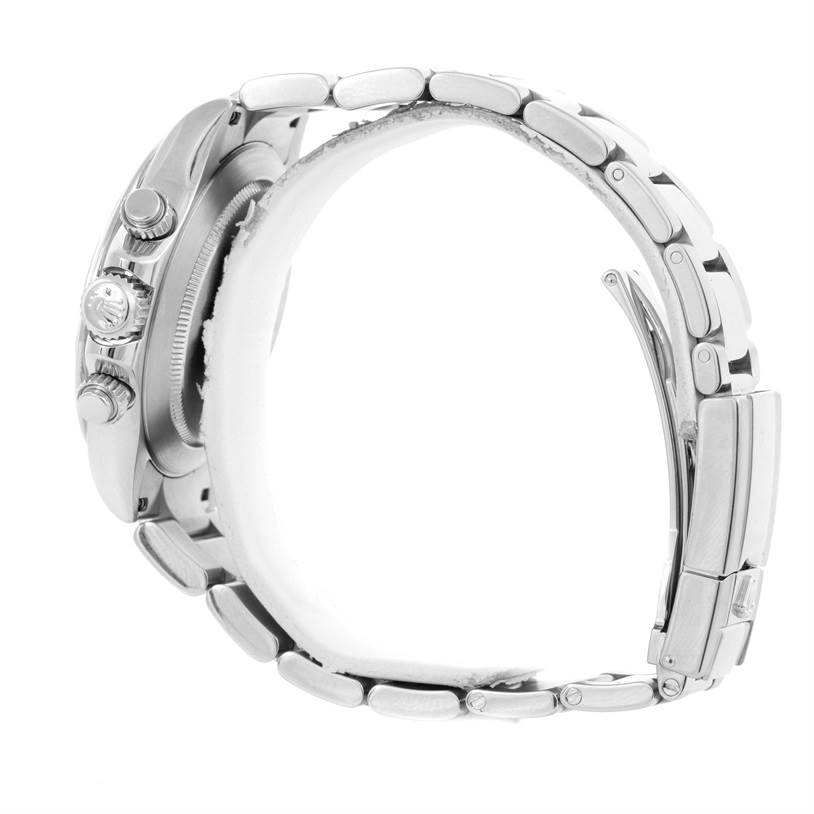 The image shows a Rolex Daytona 116520 Men's Stainless Steel Black Dial 116520 Men's Stainless Steel Black Dial watch from a side angle, highlighting the crown, pushers, and part of the metal bracelet.