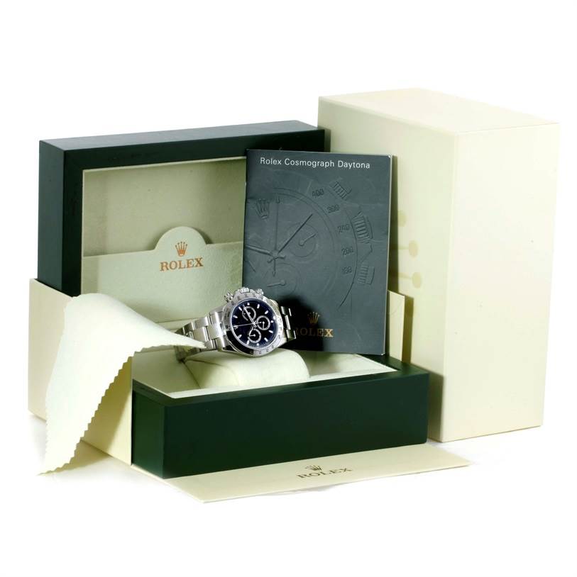 The image shows a Rolex Daytona 116520 Men's Stainless Steel Black Dial 116520 Men's Stainless Steel Black Dial watch at a front angle, along with its box, manual, and polishing cloth.