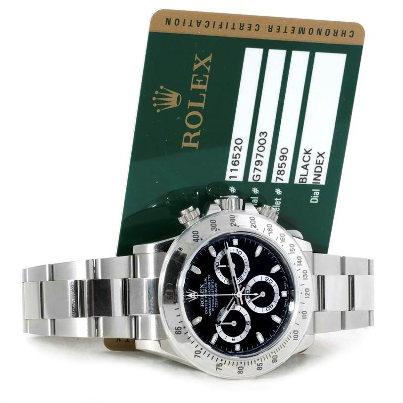 The image shows a Rolex Daytona 116520 Men's Stainless Steel Black Dial 116520 Men's Stainless Steel Black Dial watch with a black dial and its accompanying warranty card.