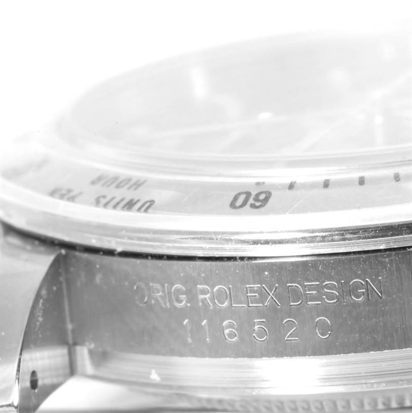 The image shows a close-up side view of the bezel and case of a Rolex Daytona 116520 Men's Stainless Steel Black Dial 116520 Men's Stainless Steel Black Dial watch, highlighting its model number (116520) engraving.