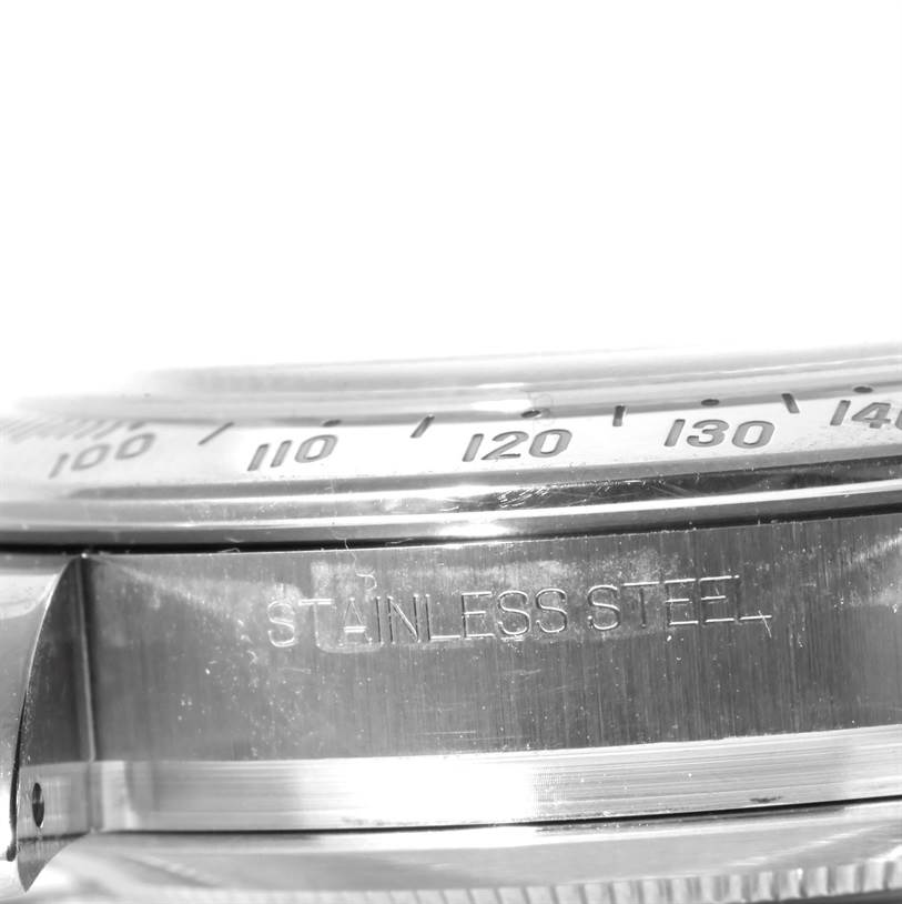 This close-up image of a Rolex Daytona 116520 Men's Stainless Steel Black Dial 116520 Men's Stainless Steel Black Dial watch shows the metal case with "Stainless Steel" engraved and part of the bezel.