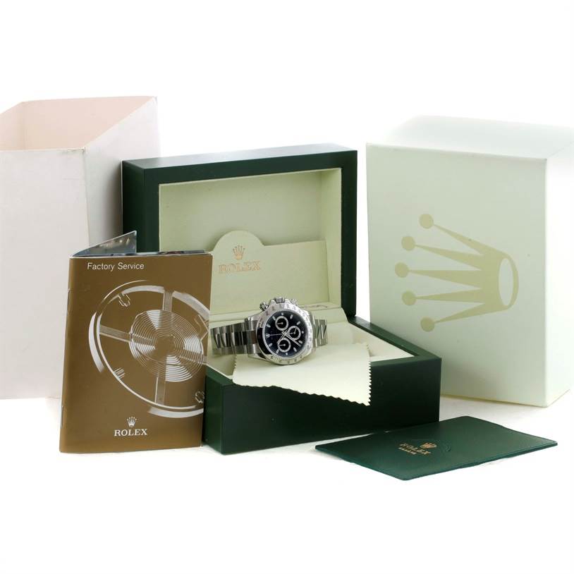The image shows a Rolex Daytona 116520 Men's Stainless Steel Black Dial 116520 Men's Stainless Steel Black Dial watch displayed at an angle in its box, with accompanying manuals and packaging.