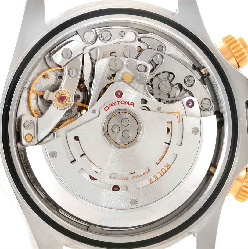 This image shows the movement and inner mechanics of a Rolex Daytona 116523 Men's Steel and Gold (two tone) Black Dial 116523 Men's Steel and Gold (two tone) Black Dial watch from a back angle.