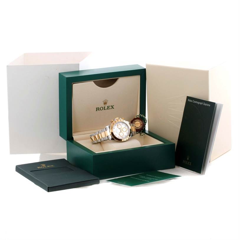 The Rolex Daytona 116523 Men's White Dial 116523 Men's White Dial watch is shown in its open green box with accompanying booklets and outer packaging.