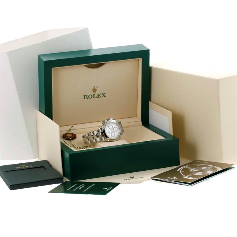 The image shows a Rolex Daytona 116520 Men's Stainless Steel White Dial 116520 Men's Stainless Steel White Dial watch inside its green box, along with manuals and accessories placed around it.