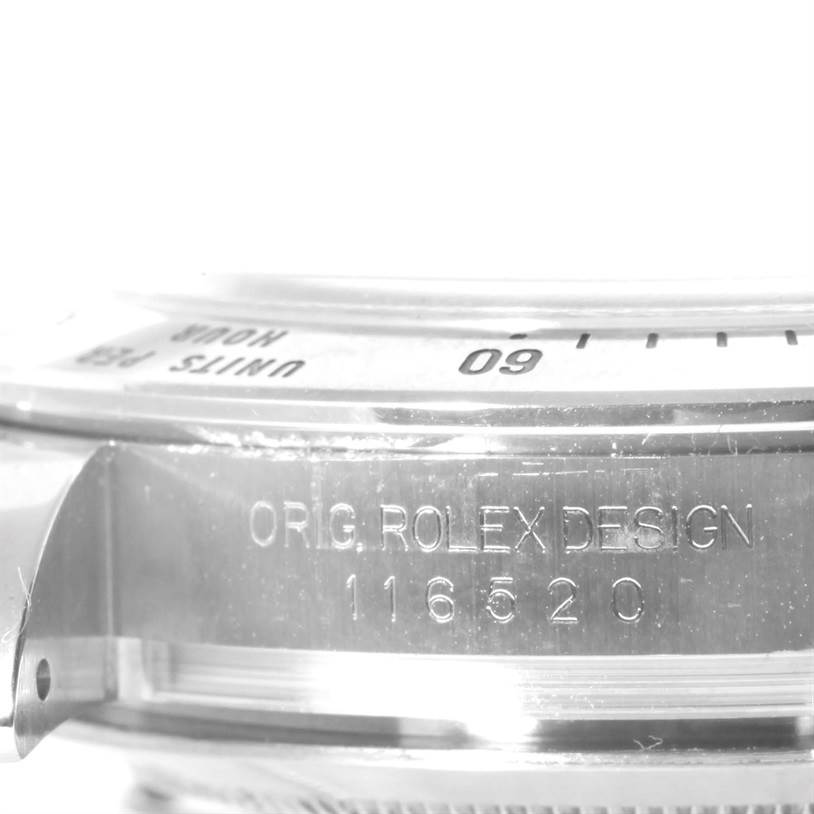 This close-up shot of the Rolex Daytona 116520 Men's Stainless Steel Black Dial 116520 Men's Stainless Steel Black Dial shows part of the bezel and engraved model details on the case side.