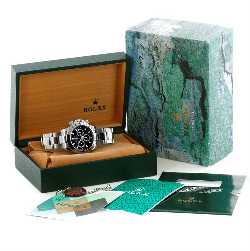 This image shows a Rolex Daytona 116520 Men's Stainless Steel Black Dial 116520 Men's Stainless Steel Black Dial watch with its box, warranty card, and additional papers, viewed from the front.