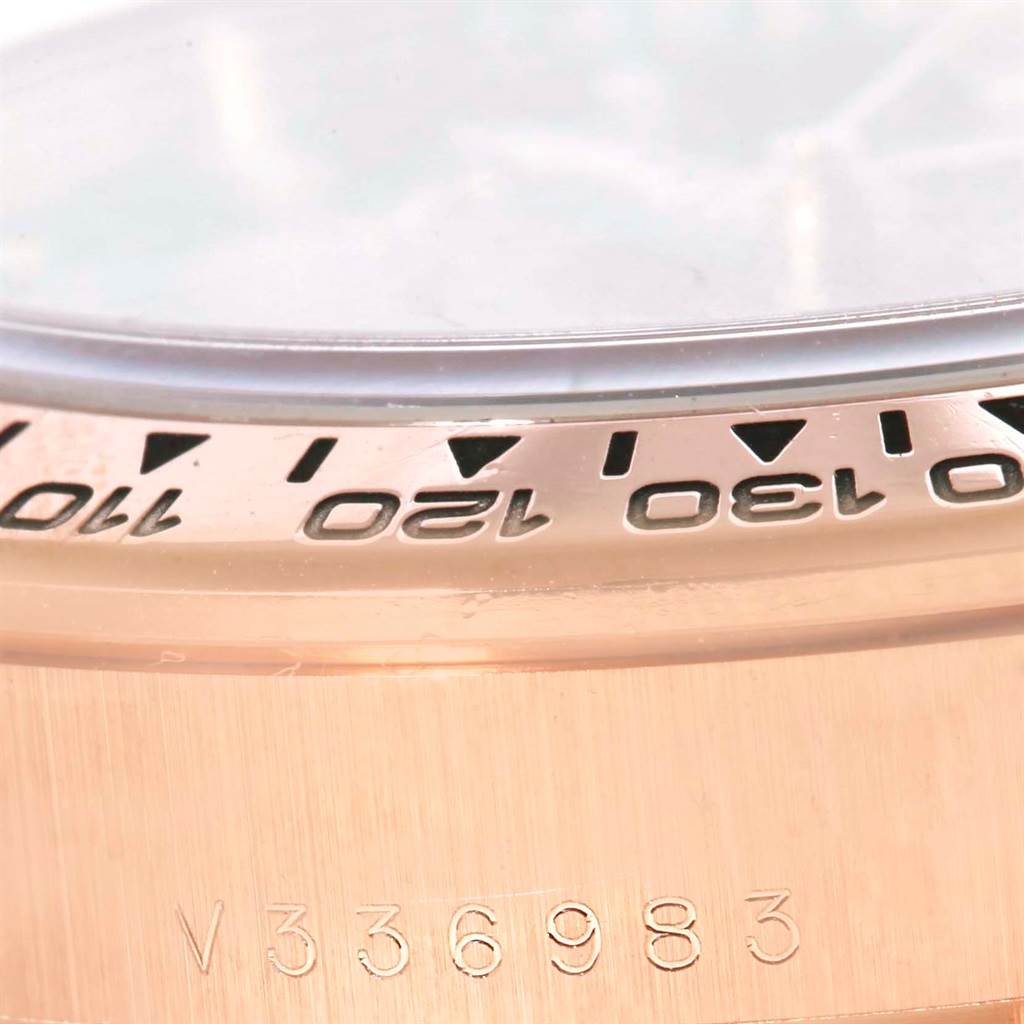 The image shows a close-up of the bezel and part of the serial number on a Rolex Daytona 116505 Men's Rose Gold Black Dial 116505 Men's Rose Gold Black Dial watch.
