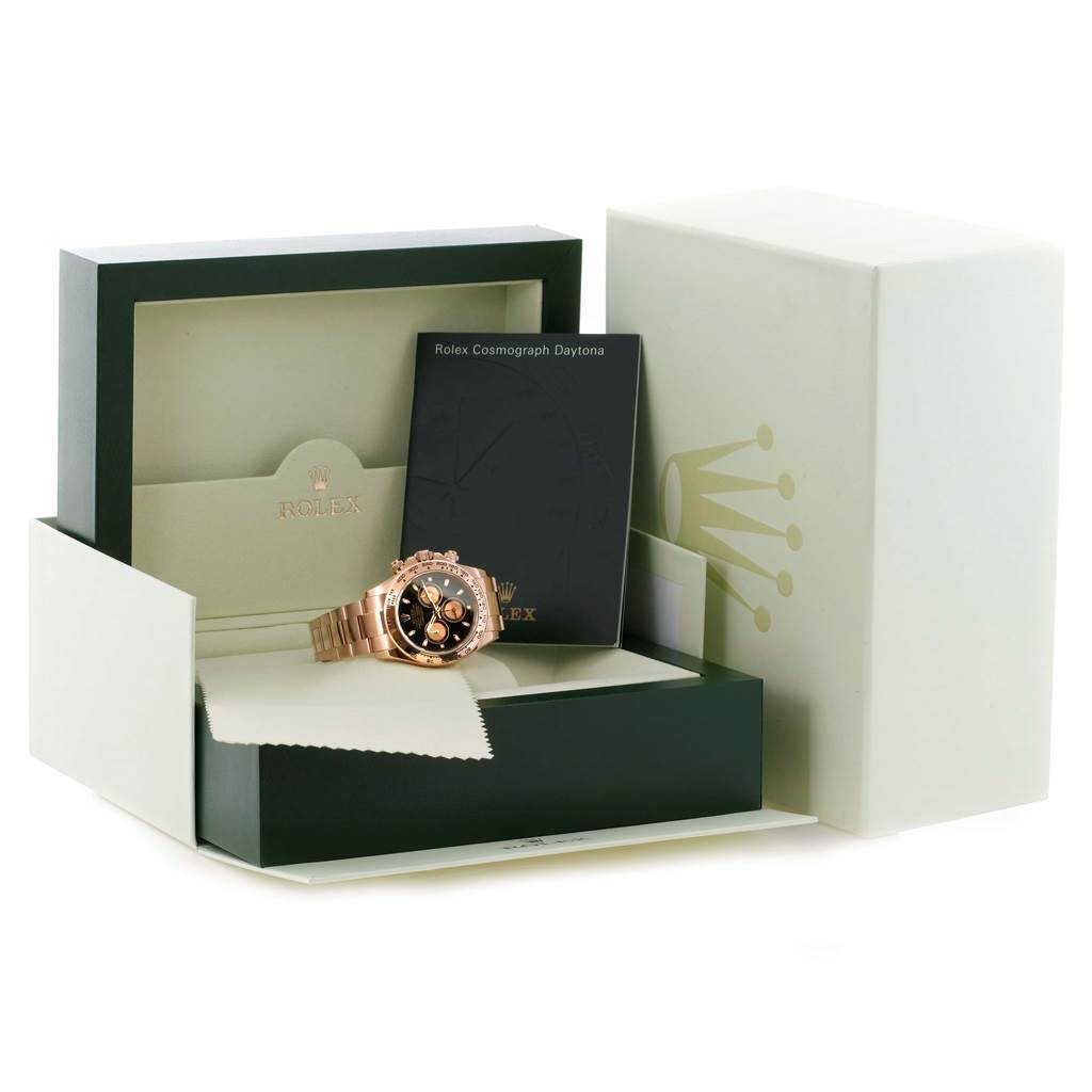 The image displays a Rolex Daytona 116505 Men's Rose Gold Black Dial 116505 Men's Rose Gold Black Dial watch in its open box with accompanying documents and a cleaning cloth.