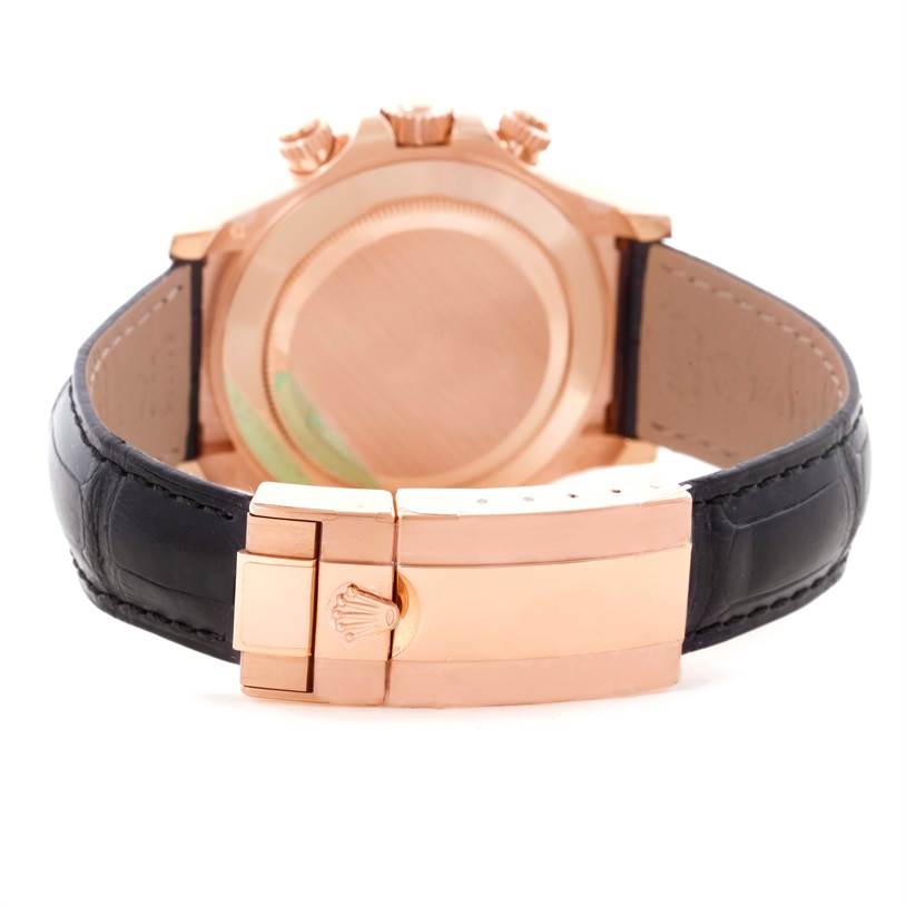 The image shows the back view of a Rolex Daytona 116515LN Men's Rose Gold Brown Dial 116515LN Men's Rose Gold Brown Dial watch, highlighting its clasp, case back, and black leather strap.