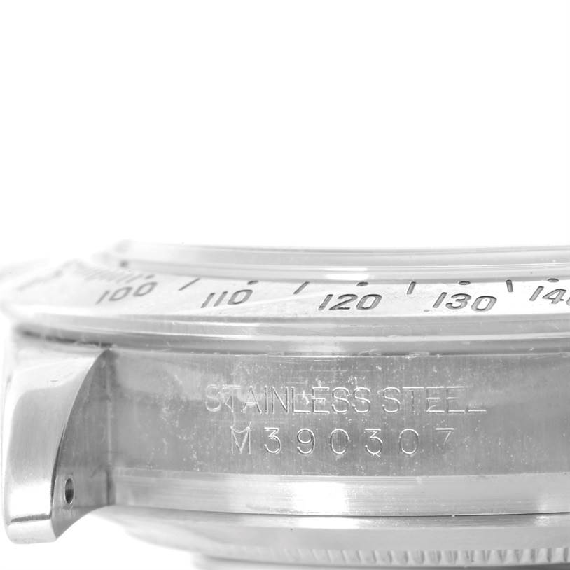 This close-up angle shows the side of the stainless steel case and part of the bezel on a Rolex Daytona 116520 Men's Stainless Steel White Dial 116520 Men's Stainless Steel White Dial watch.