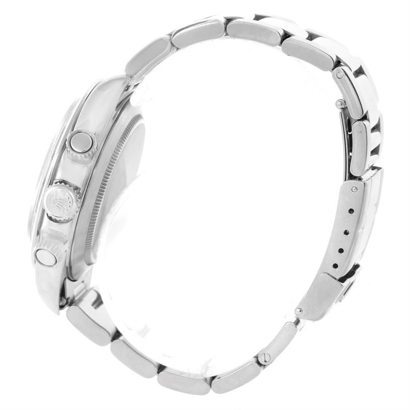 Side view of a Rolex Daytona 16520 Men's Stainless Steel Black Dial 16520 Men's Stainless Steel Black Dial, showing the crown, pushers, case, and a segment of the bracelet.