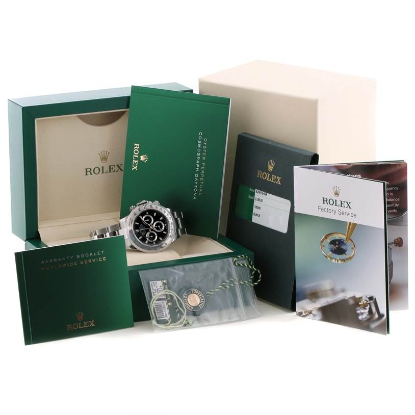 The Rolex Daytona 116520 Men's Stainless Steel Black Dial 116520 Men's Stainless Steel Black Dial watch is displayed at an angle in an open box, surrounded by its accessories and documentation.