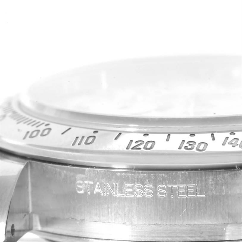 This image shows a close-up side view of the bezel and stainless steel case of a Rolex Daytona 116520 Men's Stainless Steel White Dial 116520 Men's Stainless Steel White Dial watch.