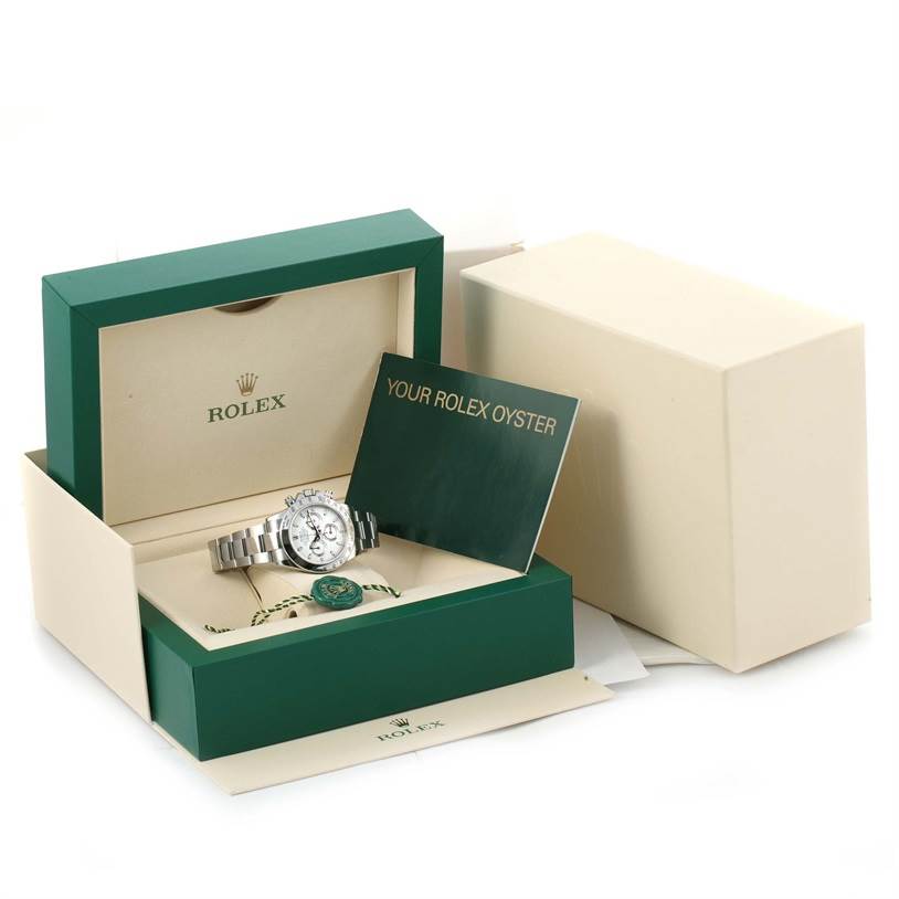 The image shows a Rolex Daytona 116520 Men
s Stainless Steel White Dial 116520 Men
s Stainless Steel White Dial watch, partially displayed in its box with accompanying accessories and documentation.