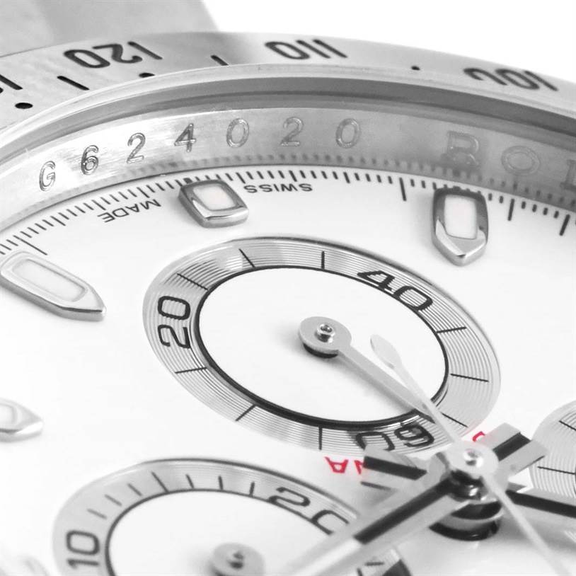 This close-up of a Rolex Daytona 116520 Men
s Stainless Steel White Dial 116520 Men
s Stainless Steel White Dial watch shows the dial and part of the bezel at an angle, highlighting the chronograph subdials.