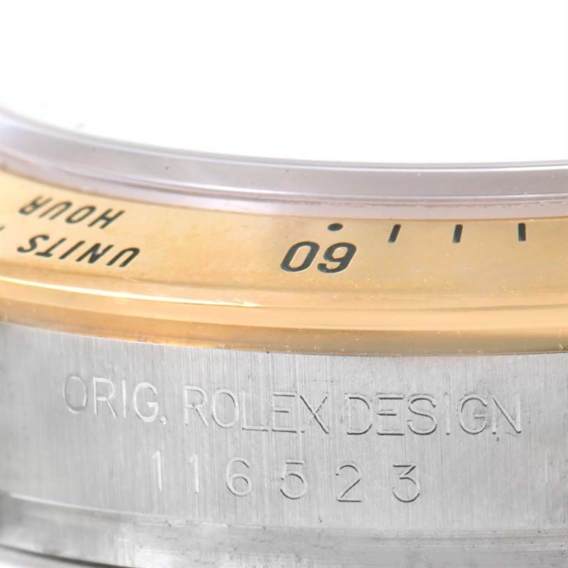 This close-up shows the bezel and part of the case of the Daytona model by Rolex, including the model number engraved.
