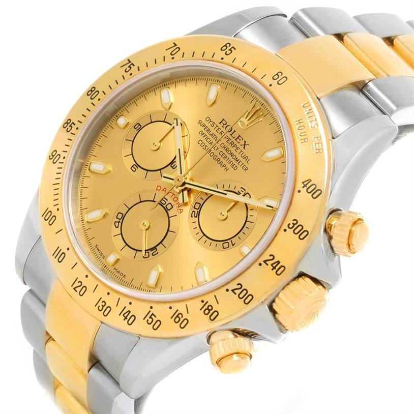 The image shows a close-up angle of the Rolex Daytona 116523 Men's Steel and Gold (two tone) Champagne Dial 116523 Men's Steel and Gold (two tone) Champagne Dial watch, highlighting its gold dial, bezel, and part of the bracelet.
