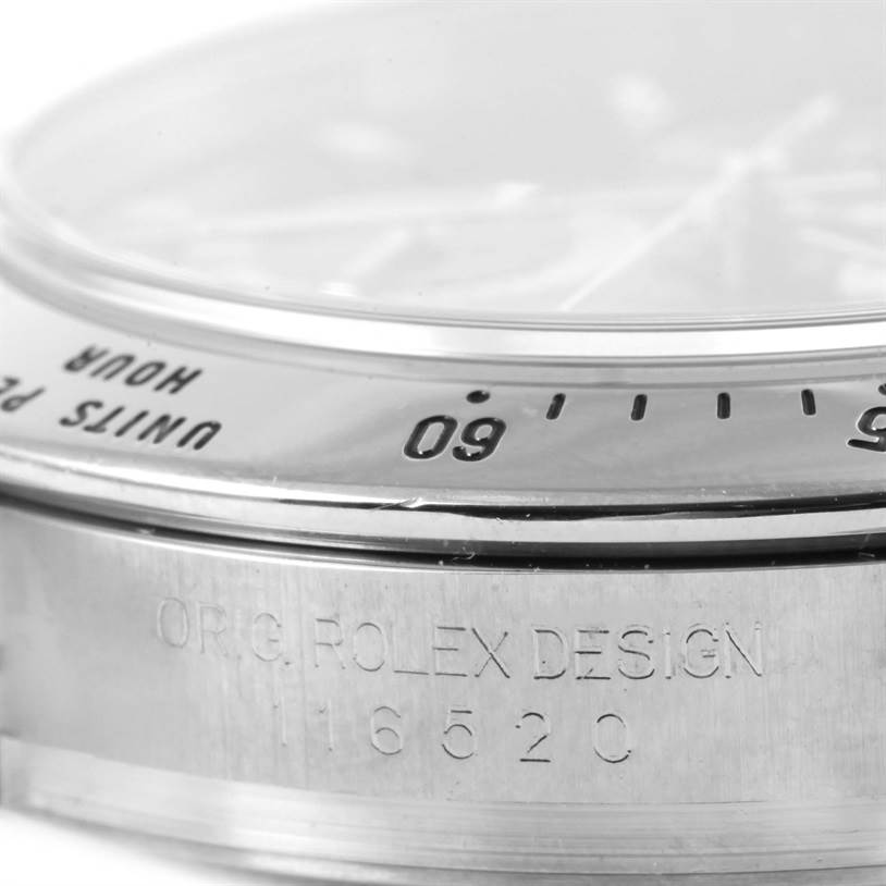 This close-up image features the bezel and case side of a Rolex Daytona 116520 Men
s Stainless Steel Black Dial 116520 Men
s Stainless Steel Black Dial model, showing engraved text and markers.