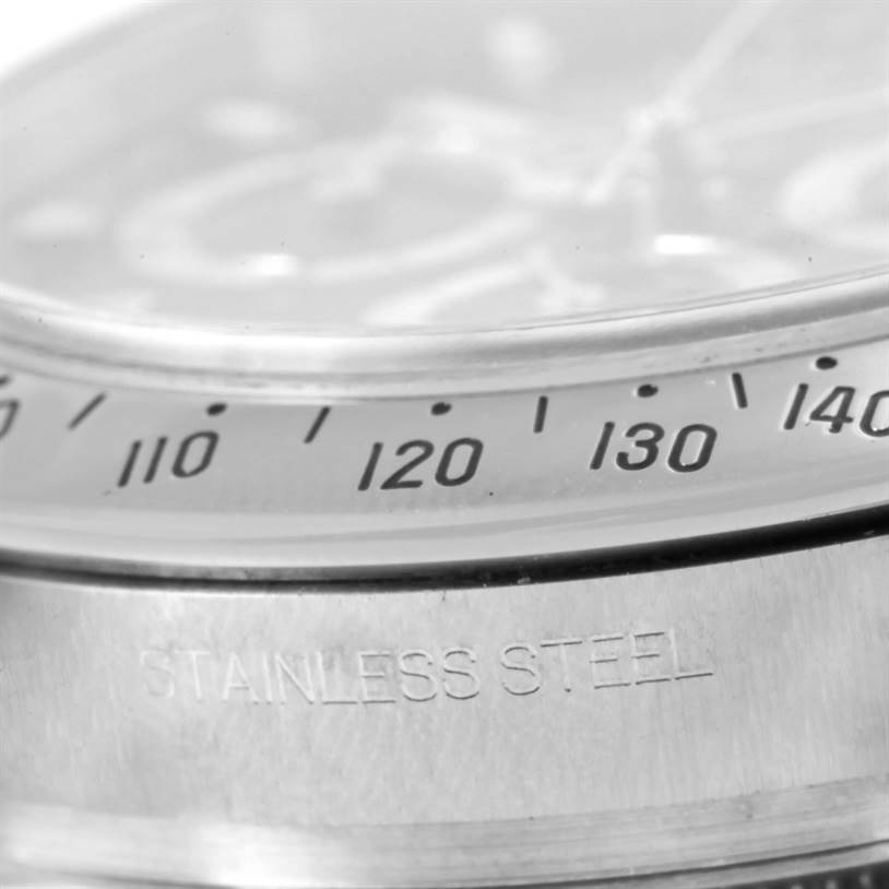 Close-up view of the bezel, tachymeter scale, and case of the Rolex Daytona 116520 Men's Stainless Steel Black Dial 116520 Men's Stainless Steel Black Dial watch, showing "STAINLESS STEEL" engraving.