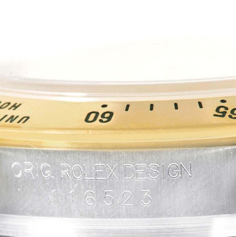 The image shows a close-up of the bezel and part of the casing of a Rolex Daytona 116523 Men's Steel and Gold (two tone) Mother of Pearl Dial 116523 Men's Steel and Gold (two tone) Mother of Pearl Dial watch, highlighting the design and model number.