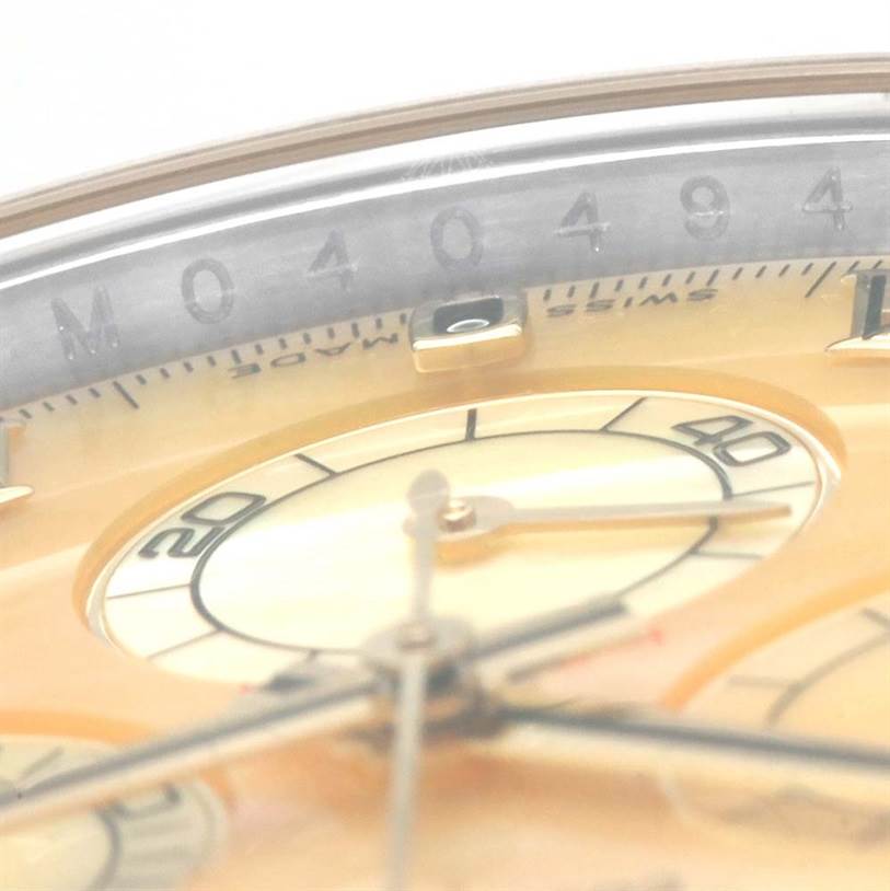 This close-up image of a Rolex Daytona 116523 Men's Steel and Gold (two tone) Mother of Pearl Dial 116523 Men's Steel and Gold (two tone) Mother of Pearl Dial watch shows part of the dial, sub-dials, and bezel.