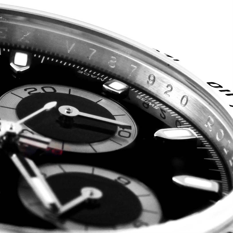 The image shows a close-up of the dial and bezel of a Rolex Daytona 116520 Men's Stainless Steel Black Dial 116520 Men's Stainless Steel Black Dial, highlighting the subdials and part of the engraved bezel.