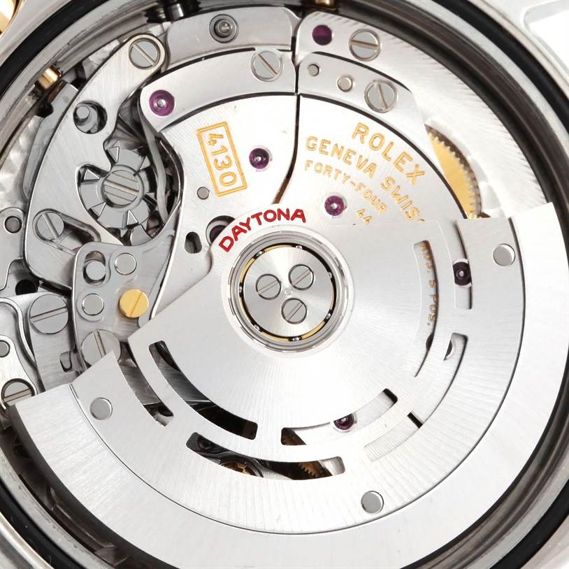The image shows a close-up of the movement mechanism inside the Rolex Daytona 116523 Men's Steel and Gold (two tone) White Dial 116523 Men's Steel and Gold (two tone) White Dial watch, highlighting its intricate components.