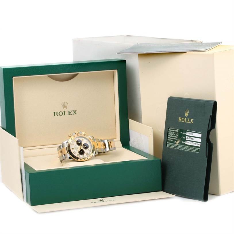 The image shows a Rolex Daytona 116523 Men's Steel and Gold (two tone) White Dial 116523 Men's Steel and Gold (two tone) White Dial watch in its open presentation box, along with its documentation and outer packaging.