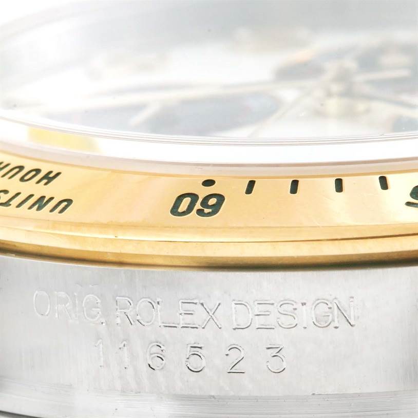 Close-up of the bezel and edge of the case, showing the model number of a Rolex Daytona 116523 Men's Steel and Gold (two tone) White Dial 116523 Men's Steel and Gold (two tone) White Dial watch.