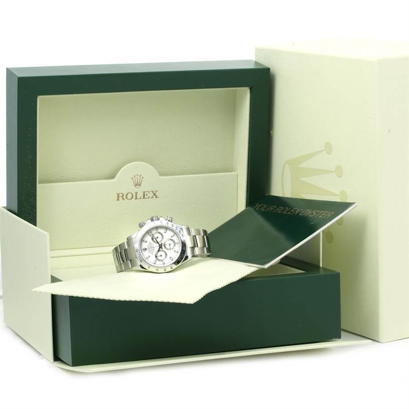The Rolex Daytona 116520 Men's Stainless Steel White Dial 116520 Men's Stainless Steel White Dial watch is shown at an angle, displayed in its box with accompanying documents and cloth.