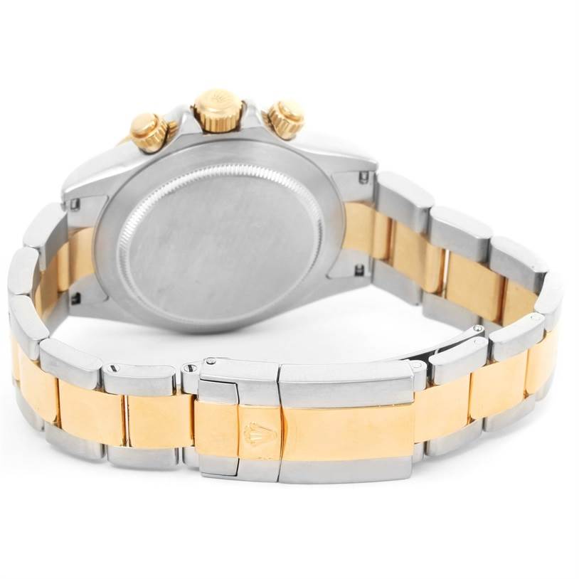 This image shows the back of a Rolex Daytona 116523 Men's Steel and Gold (two tone) Black Dial 116523 Men's Steel and Gold (two tone) Black Dial watch, featuring its gold and silver bracelet and the case back.