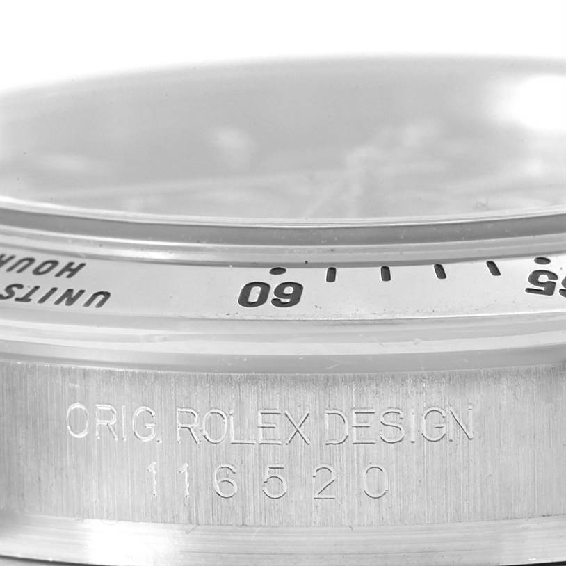 The photo shows a close-up side view of the Rolex Daytona 116520 Men's Stainless Steel Black Dial 116520 Men's Stainless Steel Black Dial model, highlighting the bezel and engraving with the model number 116520.