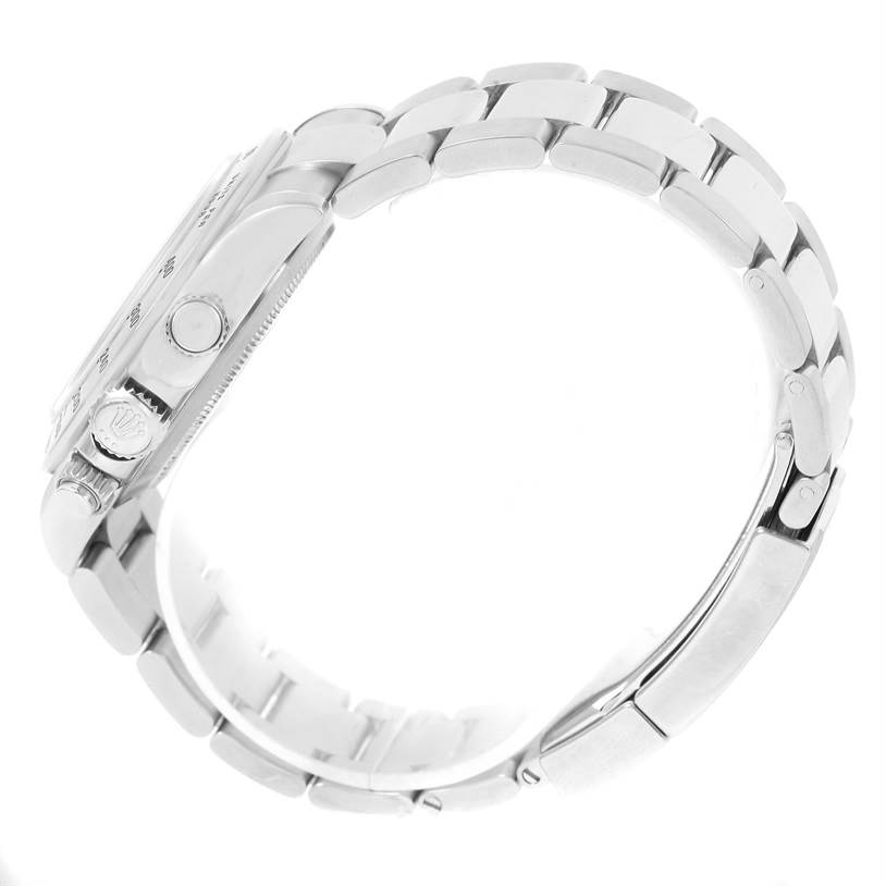 The image shows a side view of a Rolex Daytona 116520 Men's Stainless Steel White Dial 116520 Men's Stainless Steel White Dial watch, highlighting the crown, pushers, and metal bracelet links.