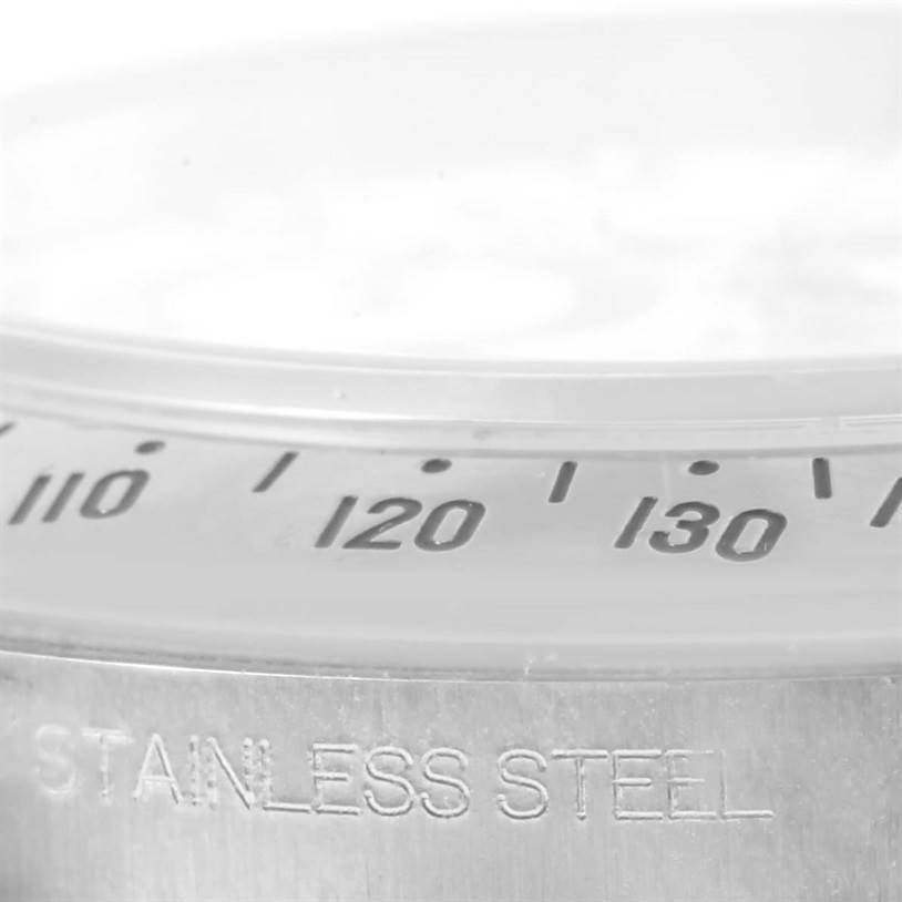 This image shows a close-up of the stainless steel bezel and tachymeter scale on a Rolex Daytona 116520 Men's Stainless Steel White Dial 116520 Men's Stainless Steel White Dial watch.