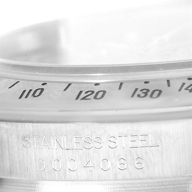 The image shows a close-up angle of the tachymeter bezel and the stainless steel casing of a Rolex Daytona 116520 Men
s Stainless Steel Black Dial 116520 Men
s Stainless Steel Black Dial watch.