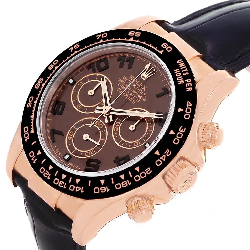 The image shows a Rolex Daytona 116515LN Men
s Rose Gold Brown Dial 116515LN Men
s Rose Gold Brown Dial watch from an angled view, highlighting its black dial, chronograph subdials, and gold case.