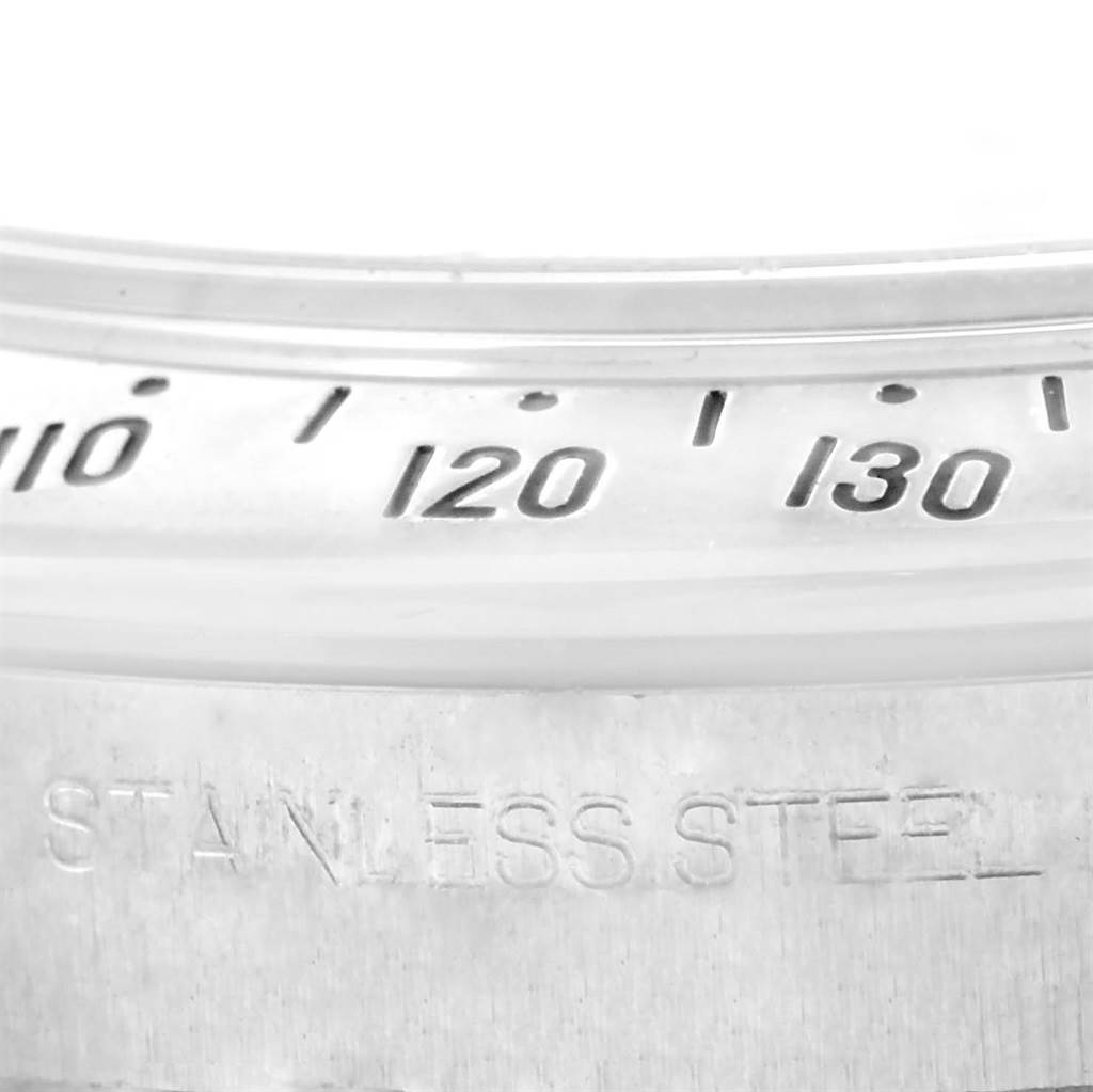 This is a close-up of the stainless steel bezel of a Rolex Daytona 116520 Men
s Stainless Steel White Dial 116520 Men
s Stainless Steel White Dial watch, featuring part of the tachymeter scale.