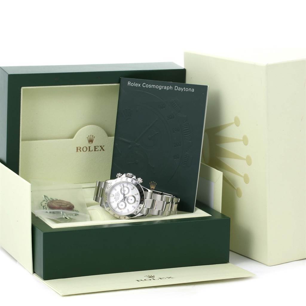 The Rolex Daytona 116520 Men
s Stainless Steel White Dial 116520 Men
s Stainless Steel White Dial watch is shown in an open box with its bracelet flat, accompanied by a manual and accessories.