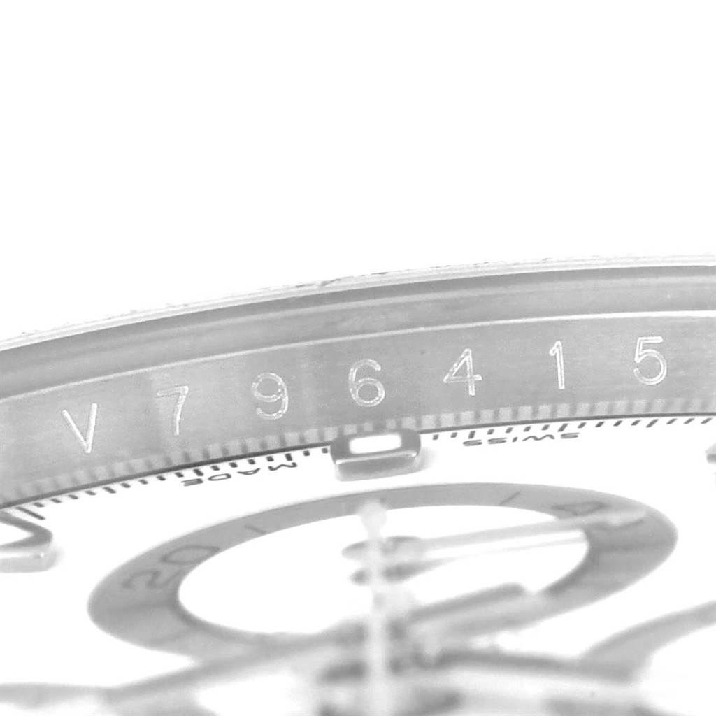 The image shows a close-up of the serial number and partial dial of a Rolex Daytona 116520 Men
s Stainless Steel White Dial 116520 Men
s Stainless Steel White Dial watch.