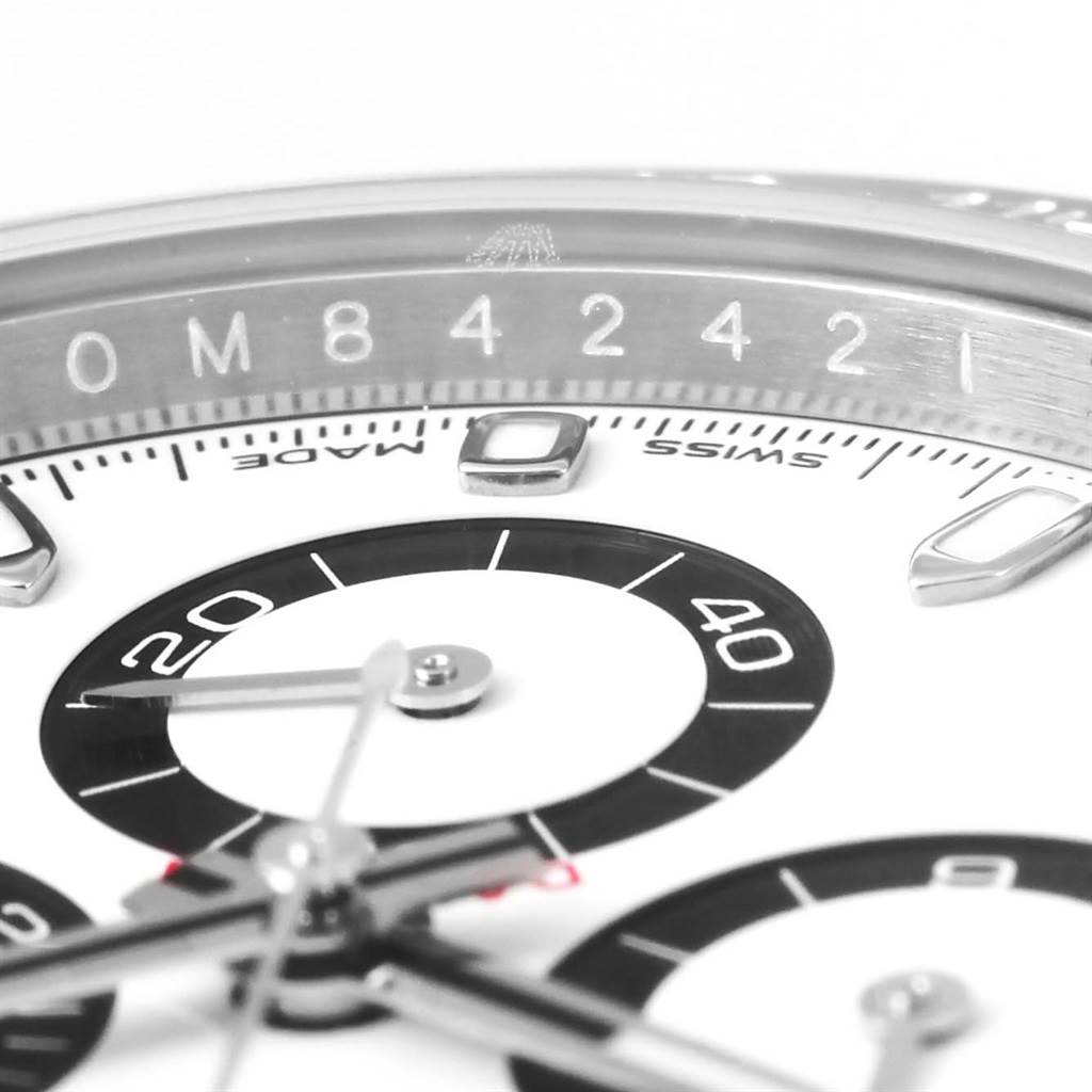 This close-up image of the Rolex Daytona 116500 Men's Stainless Steel White Dial 116500 Men's Stainless Steel White Dial watch showcases part of the bezel, the dial, and the sub-dials.