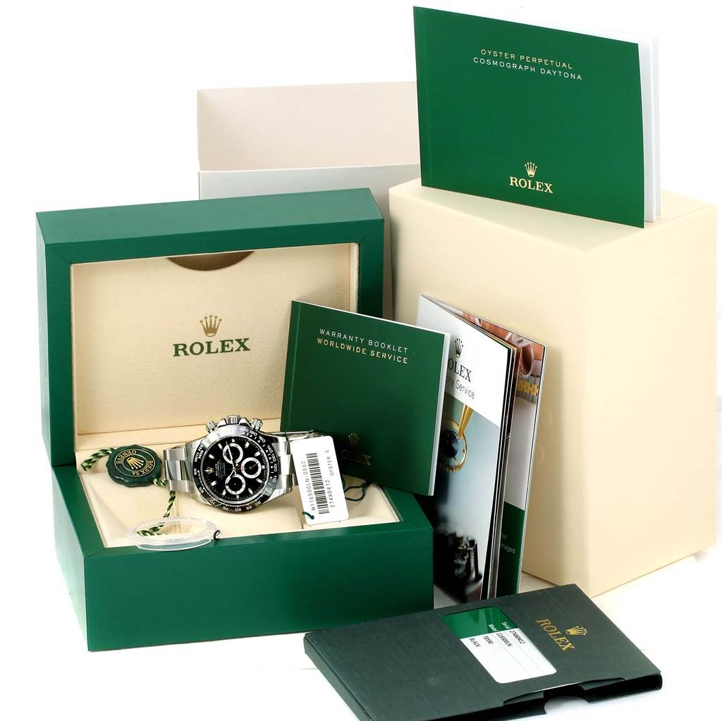 The image shows a Rolex Daytona 116500 Men's Stainless Steel Black Dial 116500 Men's Stainless Steel Black Dial watch and its accessories, including the box, warranty booklet, and manuals, from a front angle.