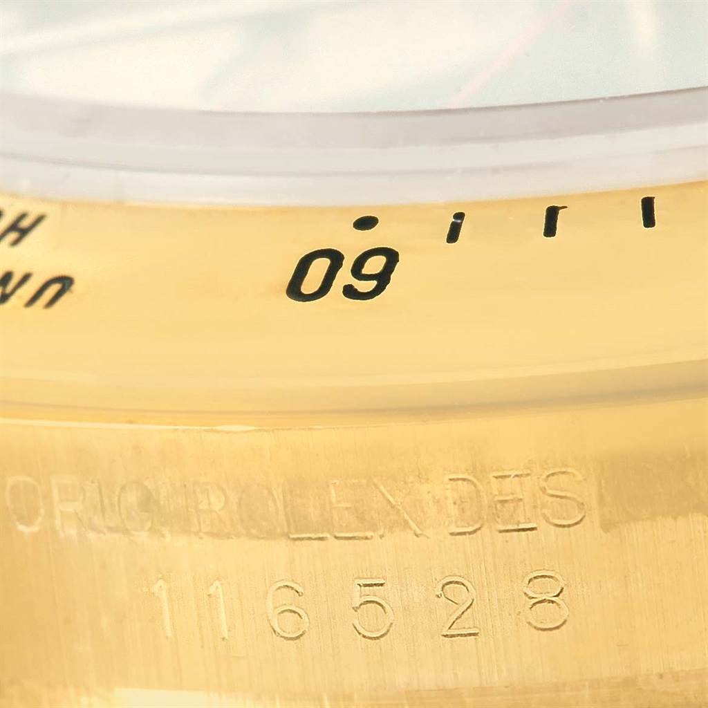 This image shows a close-up of the bezel and case with the model number of a Rolex Daytona 116528 Men's Yellow Gold Black Dial 116528 Men's Yellow Gold Black Dial watch.