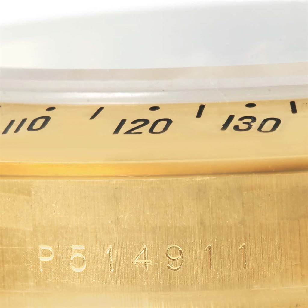 The image shows a partial view of the bezel and serial number engraving on a Rolex Daytona 116528 Men's Yellow Gold Black Dial 116528 Men's Yellow Gold Black Dial watch.