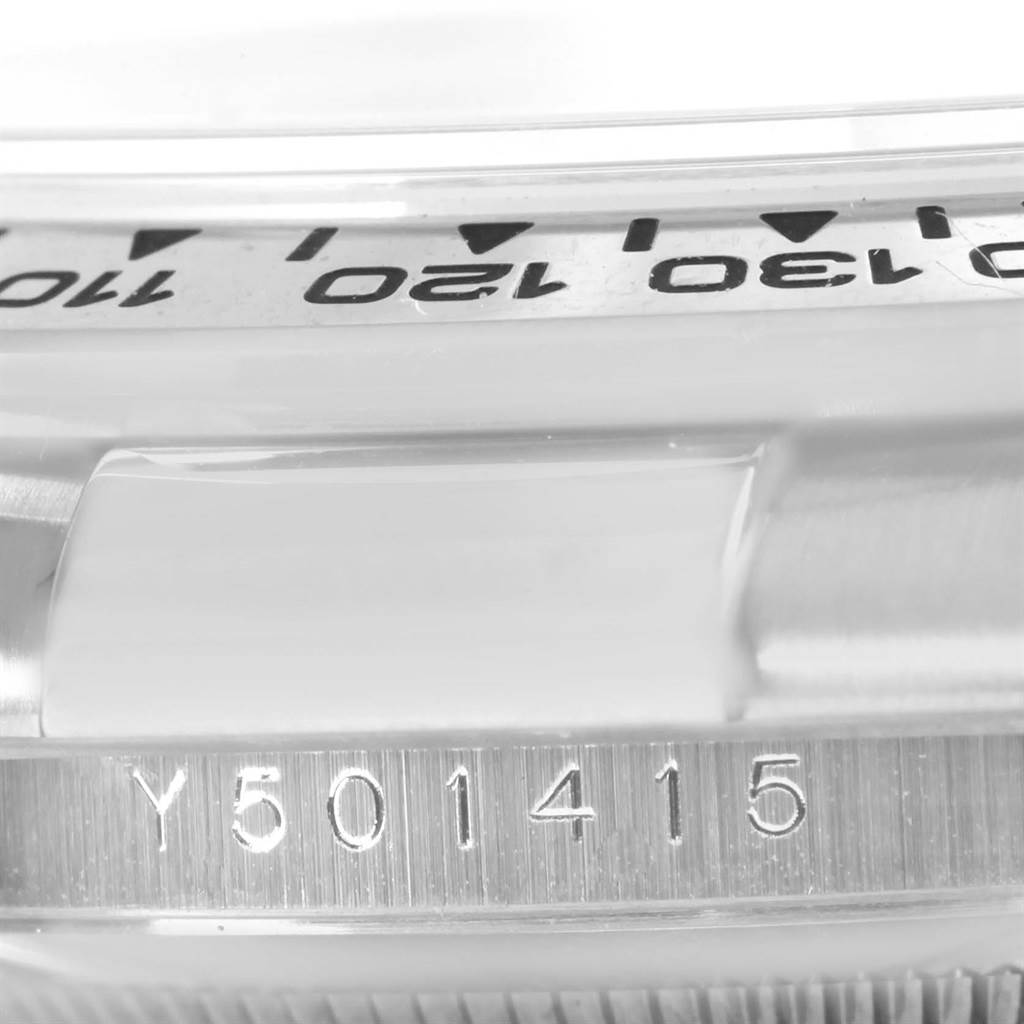 The image shows a close-up of the case side and bezel with engraved tachymeter markings of a Rolex Daytona 116519 Men's White Gold White Dial 116519 Men's White Gold White Dial watch.