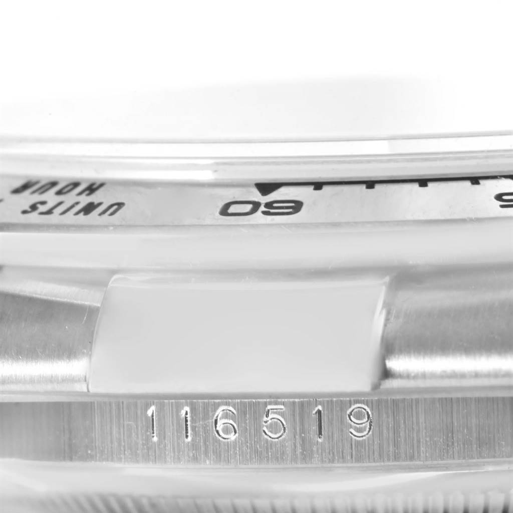 This close-up angle shows the bezel and model number (116519) on a Rolex Daytona 116519 Men's White Gold White Dial 116519 Men's White Gold White Dial watch.