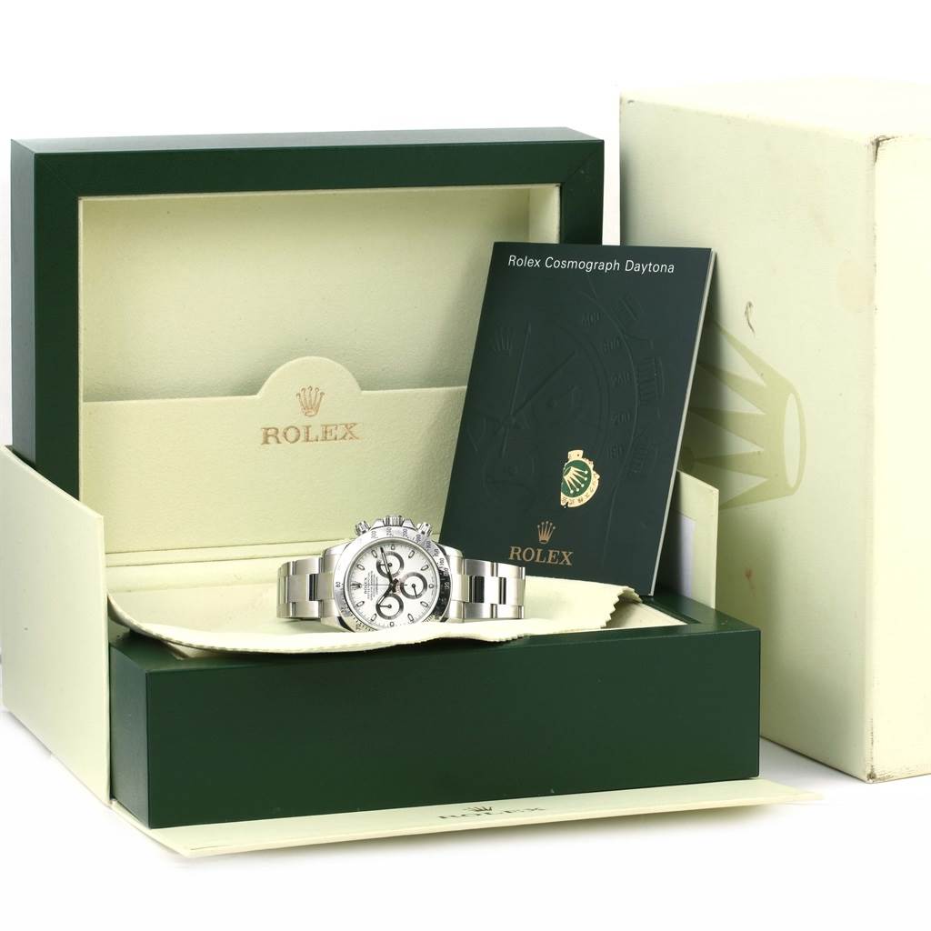 The image shows a Rolex Daytona 116520 Men
s Stainless Steel White Dial 116520 Men
s Stainless Steel White Dial watch from a frontal angle inside its green box, accompanied by a booklet.