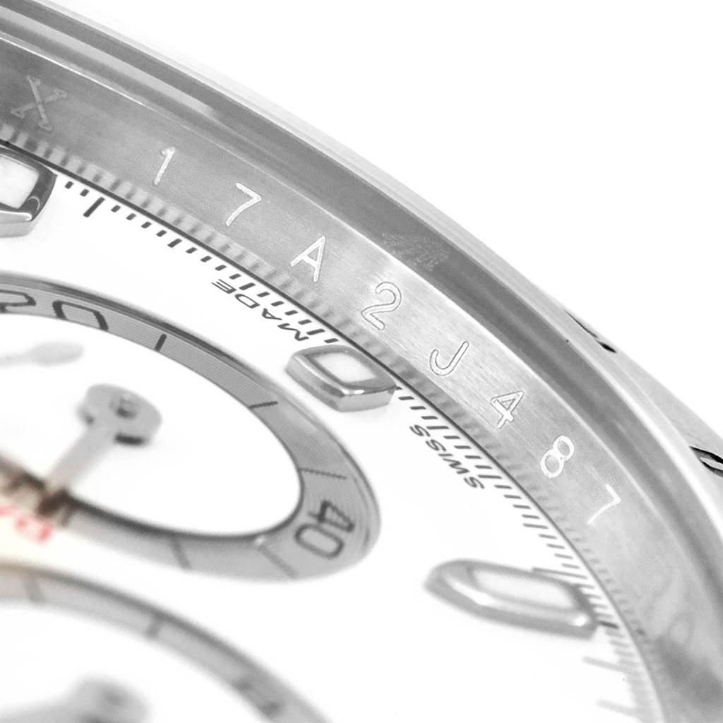 This close-up image of a Rolex Daytona 116520 Men
s Stainless Steel White Dial 116520 Men
s Stainless Steel White Dial watch features part of the dial, bezel, and an engraved number.