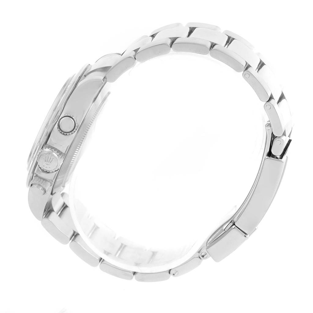 The image shows a side view of a Rolex Daytona 116520 Men's Stainless Steel White Dial 116520 Men's Stainless Steel White Dial watch, highlighting the crown and pushers on the case, as well as the metal bracelet.