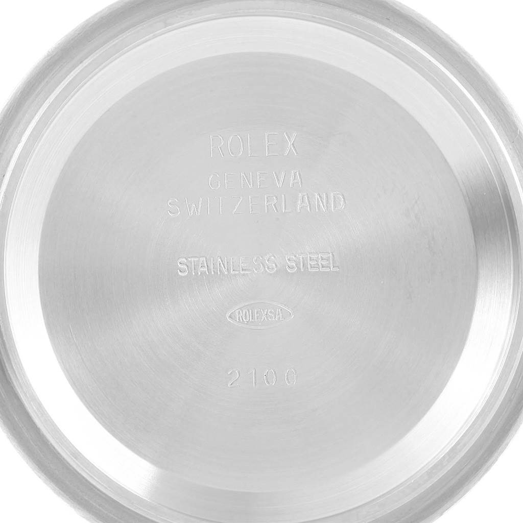 This image shows the stainless steel backing of a Rolex Daytona 116520 Men's Stainless Steel White Dial 116520 Men's Stainless Steel White Dial watch, engraved with the brand, origin, and material.